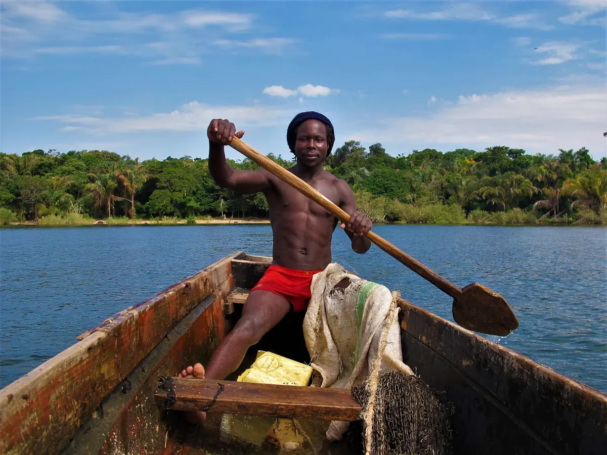 A fisherman paddling a canoe on Lake Victoria