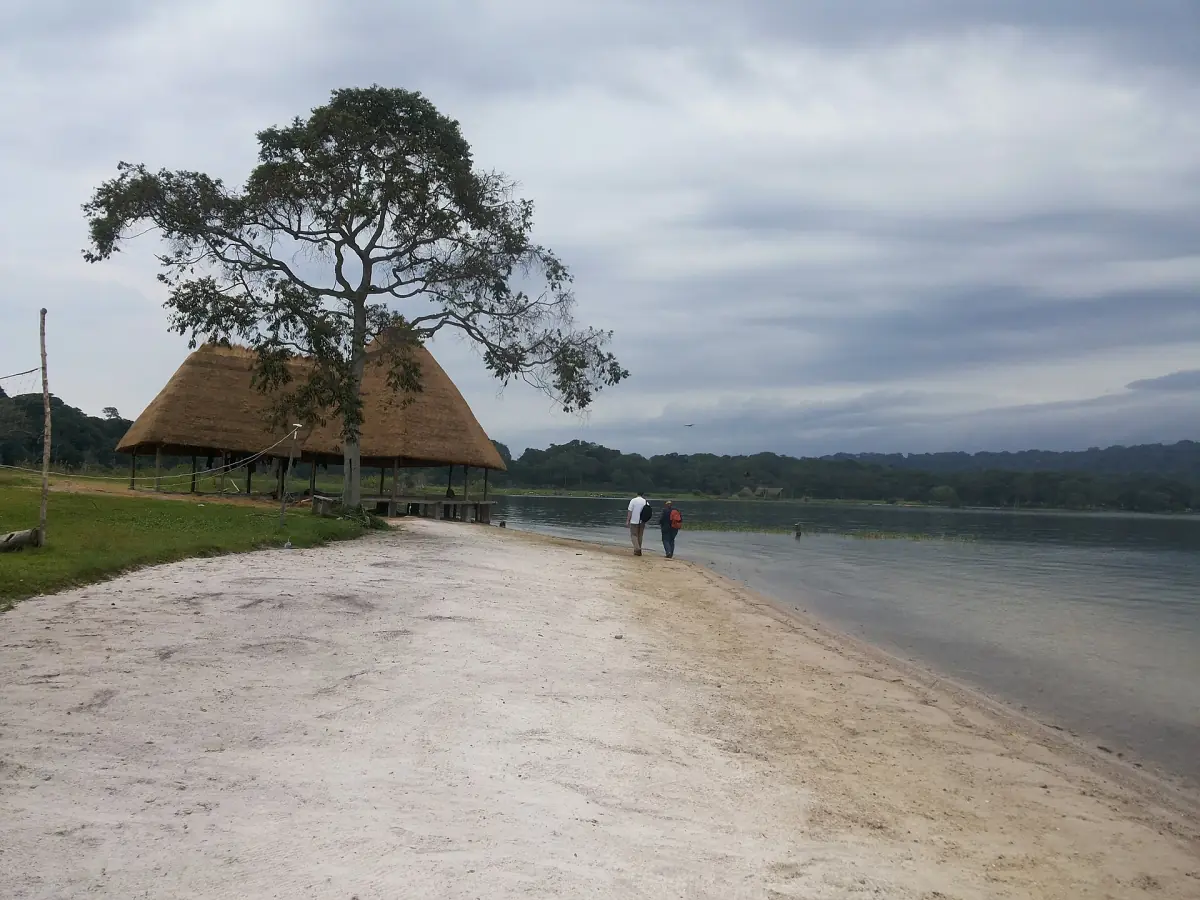 A thatched shelter on a pale lake beach
